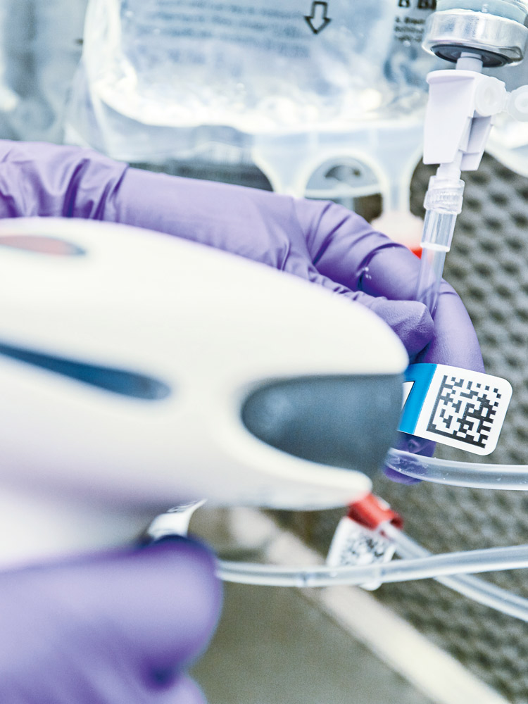 Hands of a medical worker scanning a QR code