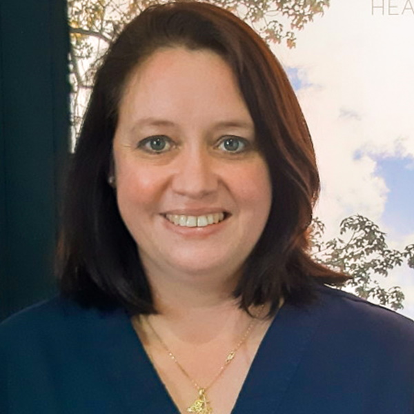 In a close-up there is a woman smiling with teeth